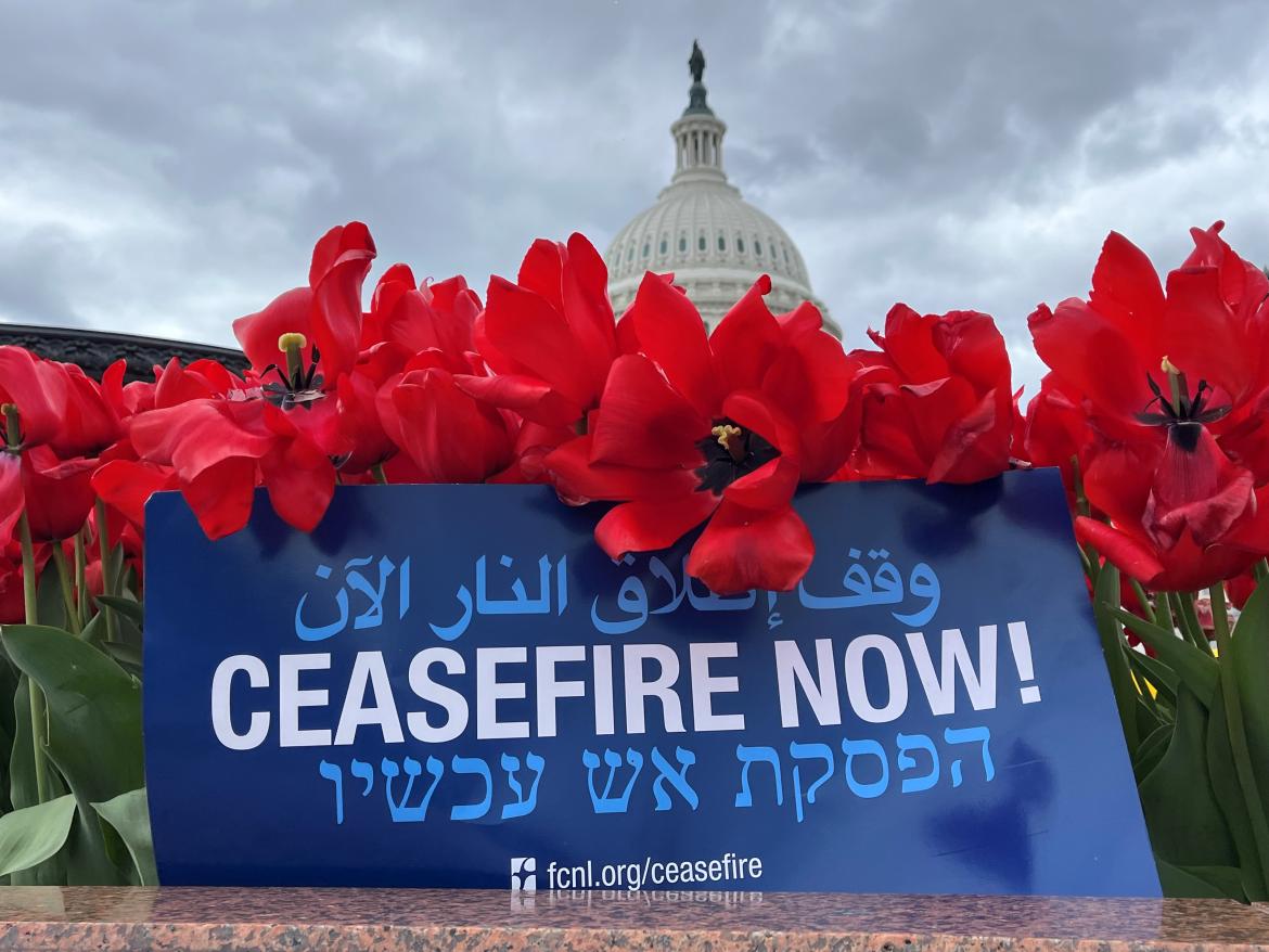 Ceasefire sign by the Capitol with flowers