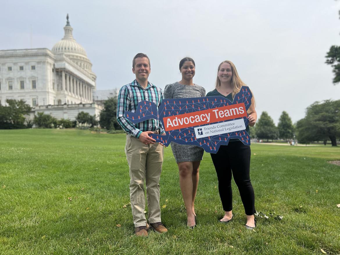 Advocacy Teams organizers Tim, Mwan and Sarah hold "Advocacy Teams" sign in front of U.S. Capitol
