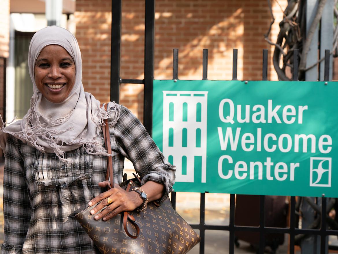 Woman Smiles and walks out of Quaker Welcome Center 