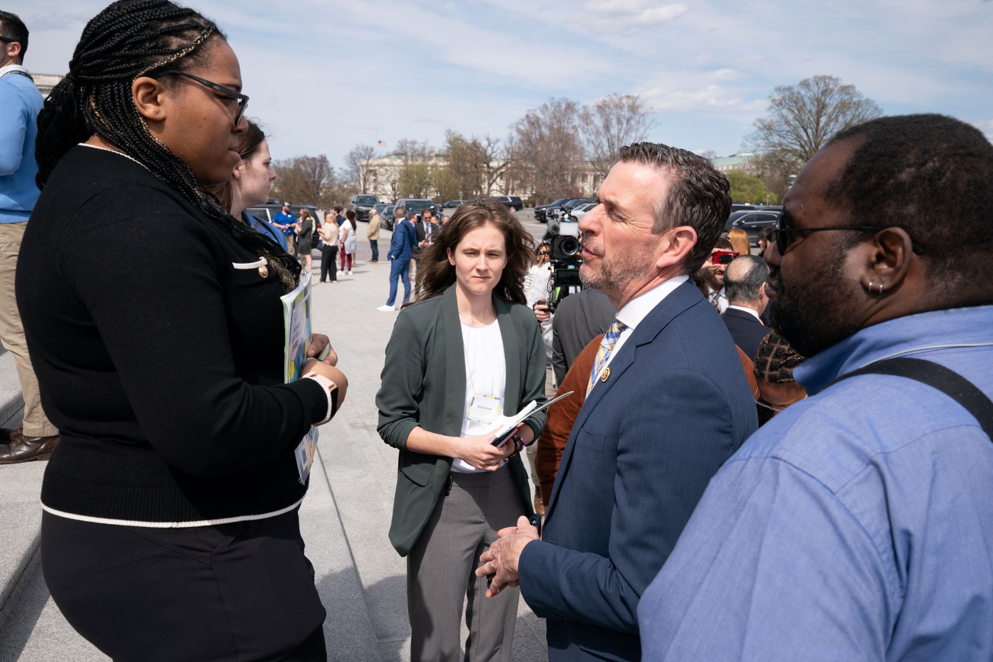 SLW 2025 participants talking with a member of Congress on the steps
