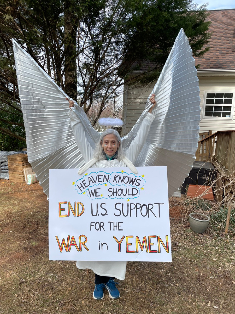Woman dressed as an Angel with a sign reading "Heaven Knows we should End U.S. Support for the War in Yemen"
