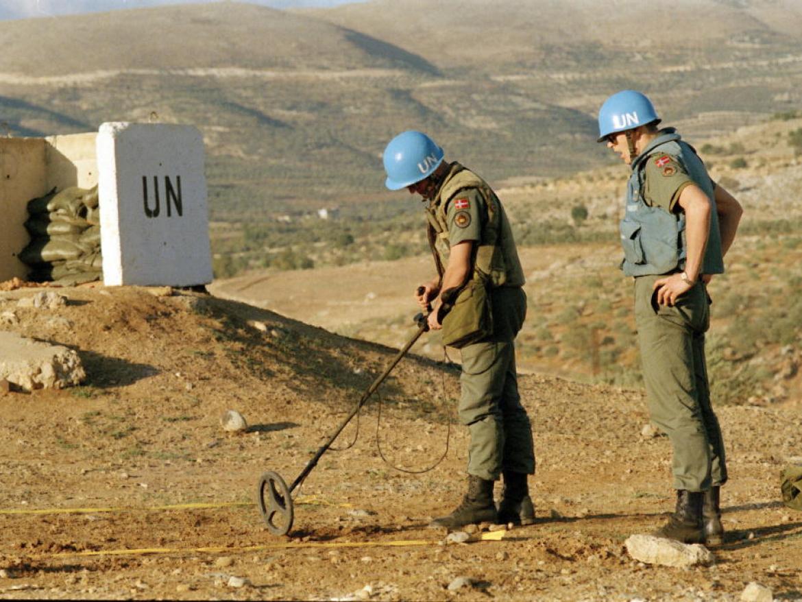 UN soldiers sweep for landmines.