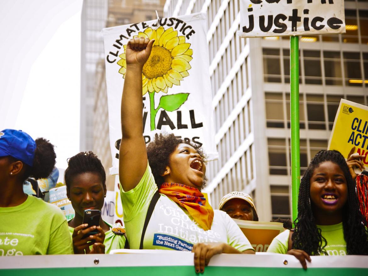 Marchers at the People's Climate march call for  Joe Brusky Climate Justice for All