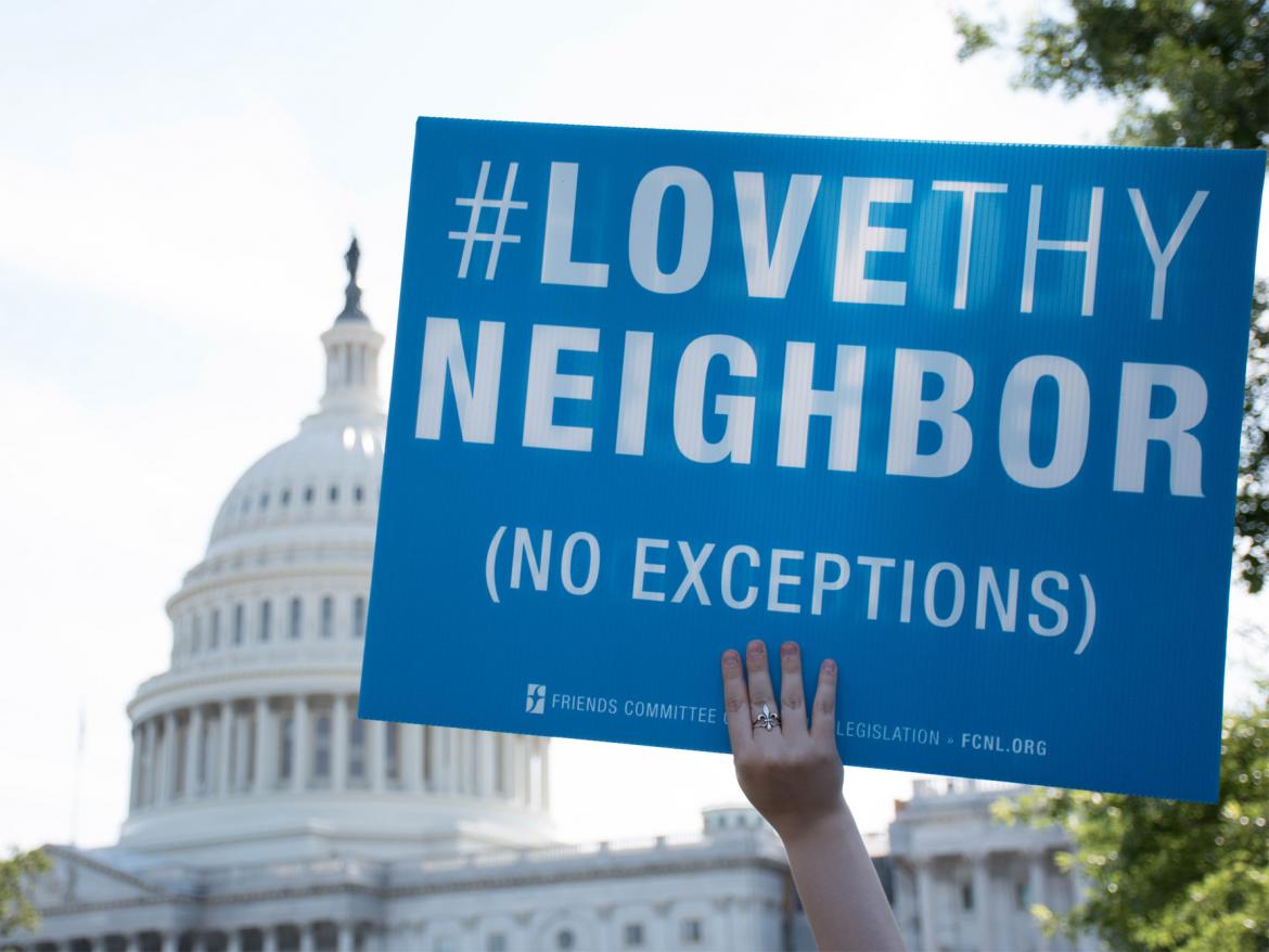 Love Thy Neighbor sign in front of U.S. Captiol