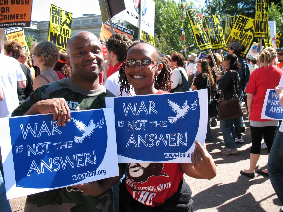 Advocates holding "War is Not the Answer" signs 