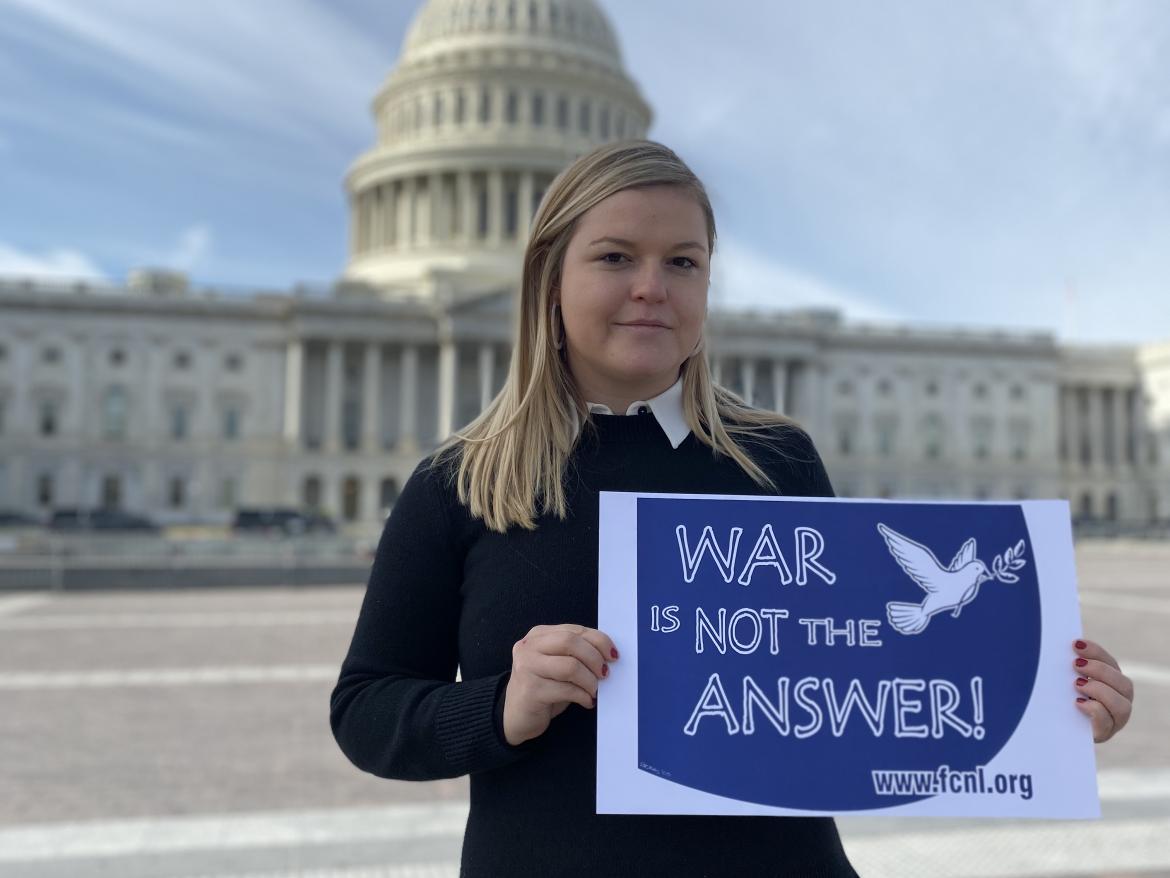 Monica Montgomery holding "War is Not the Answer" sign