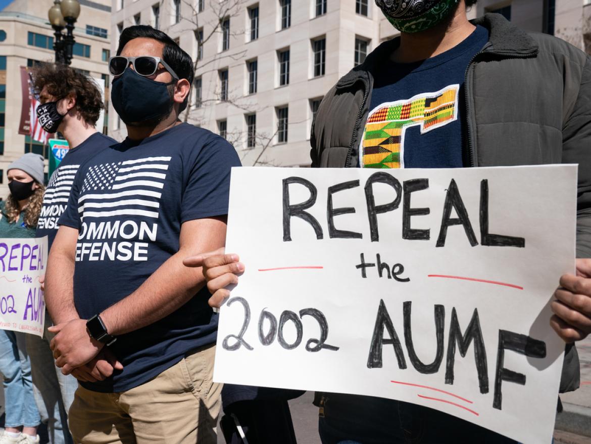 DC Advocacy team witness at White House holding "Repeal the 2002 AUMF" signs