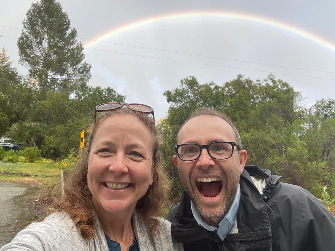 Bridget Moix and Stephen Donahoe under a rainbow