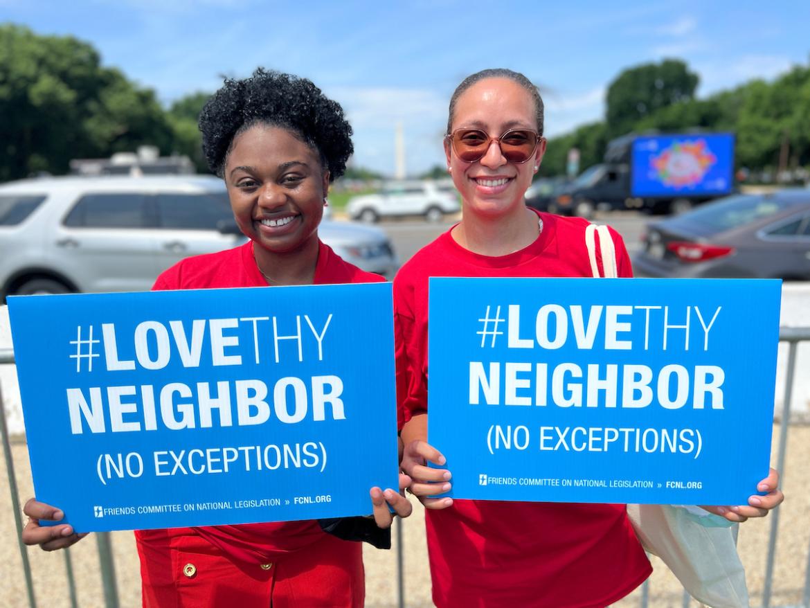 Summer interns Chelsea Leon and Seneca Ransom hold Love Thy Neighbors signs at Interfaith gun violence vigil in Washington, D.C. June 2022