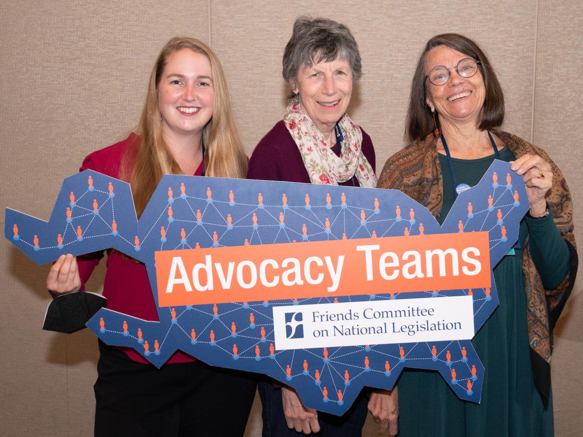 Advocacy Teams members smile and hold "Advocacy Teams" sign