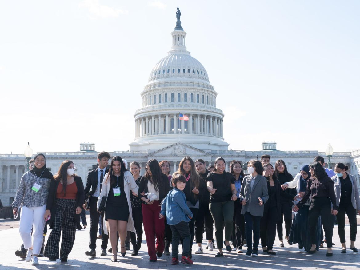 Group of Spring Lobby Weekend advocates walk together in front of the U.S. Captiol Building