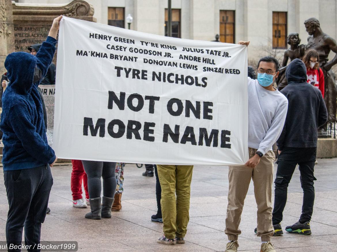 Protesters hold sign at gathering for Tyre Nichols.