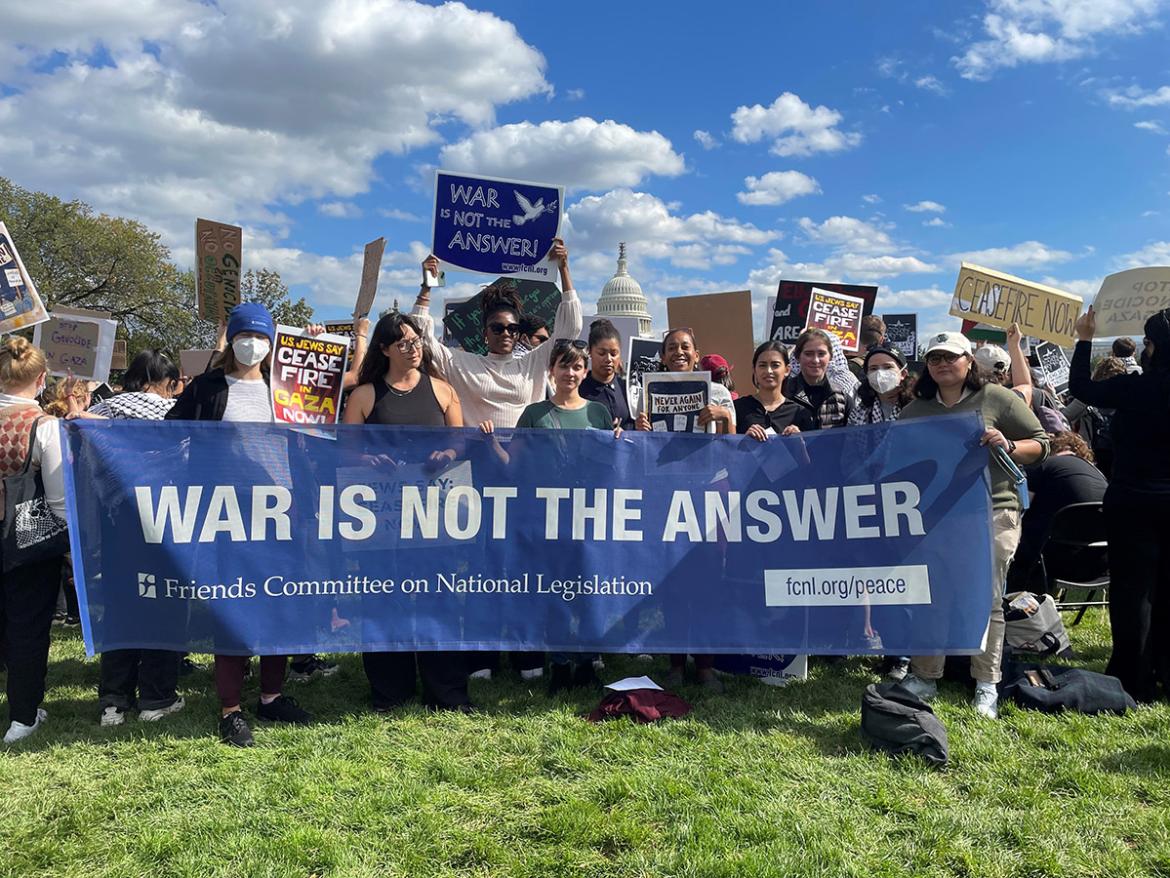 FCNL advocates hold a banner reading "War is Not the Answer" at a ceasefire protest.