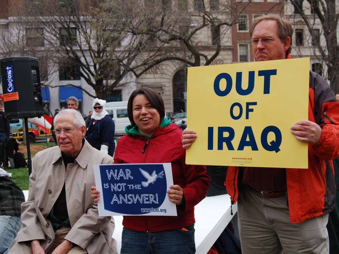 Demonstrators hold signs saying "Out of Iraq" and "War is Not the Answer" at a protest against the Iraq war.