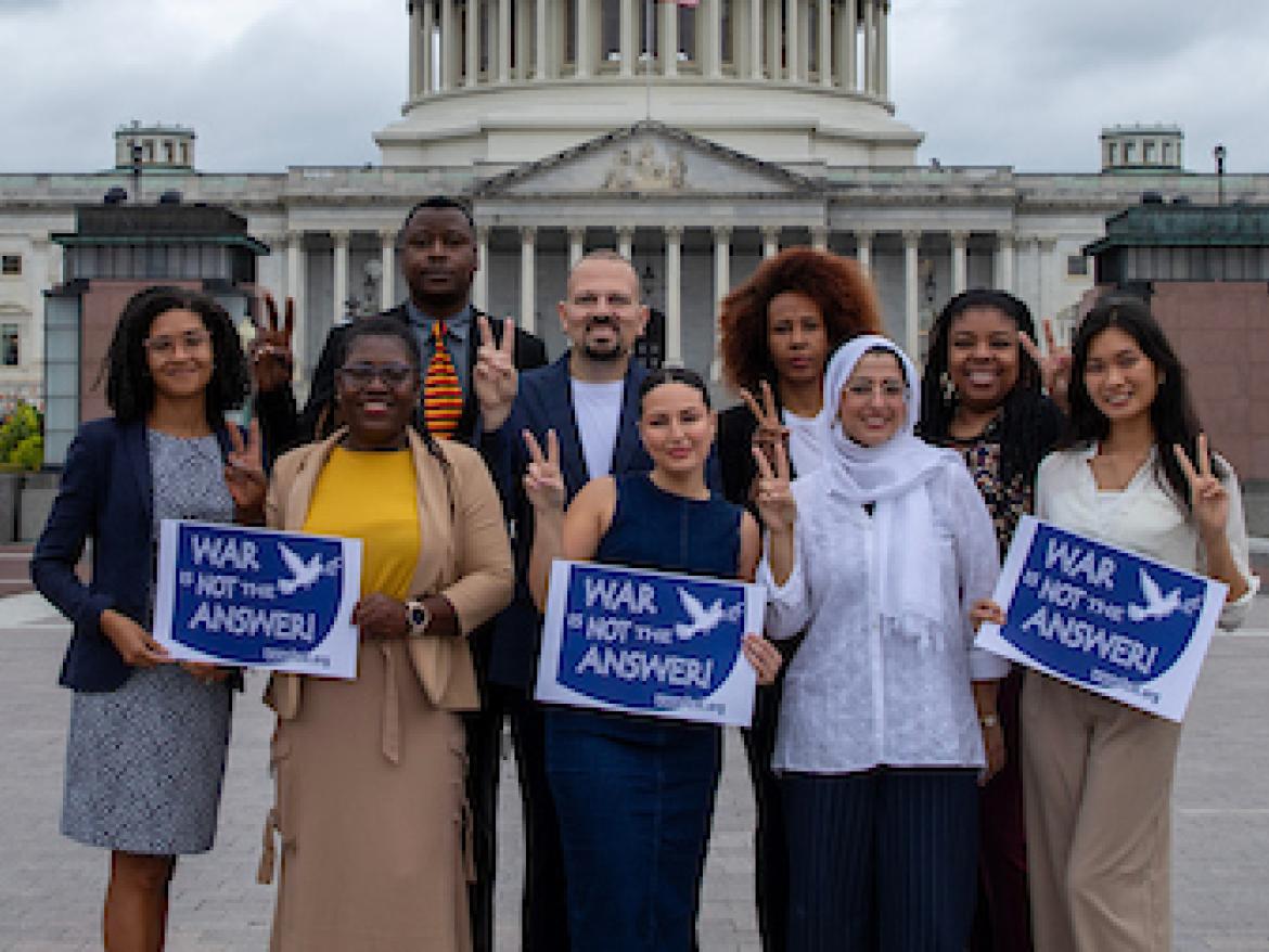 Diaspora Gathering 2024 in front of Capitol with signs saying "War is Not the Answer'