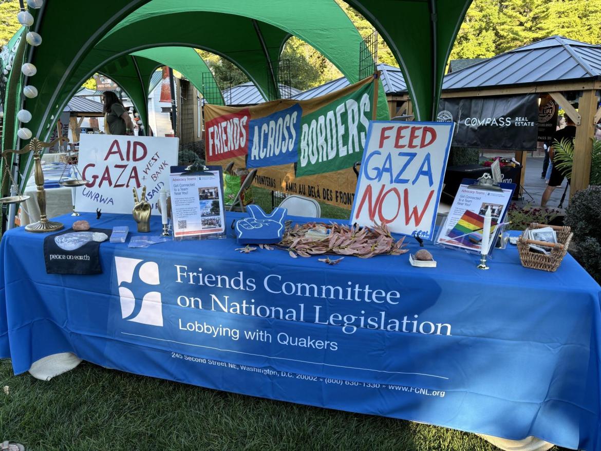FCNL's table at a Neil Young concert displaying message for peace. 
