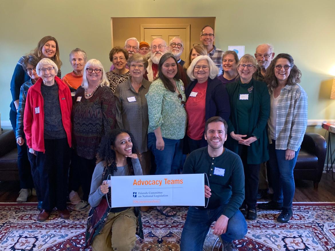 Group of advocates smiling behind an Advocacy Teams banner