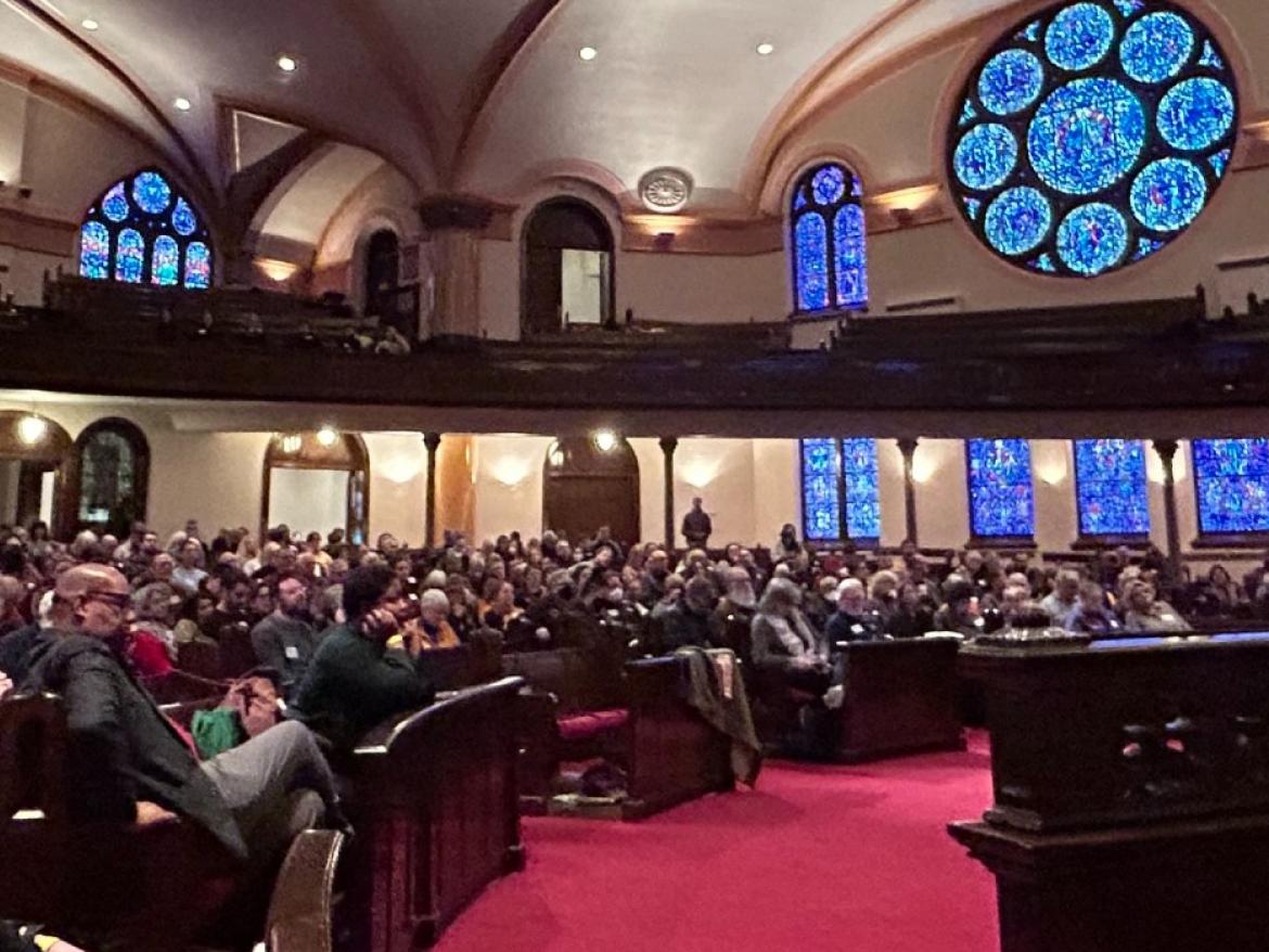 Faith leaders gathered in a church sanctuary