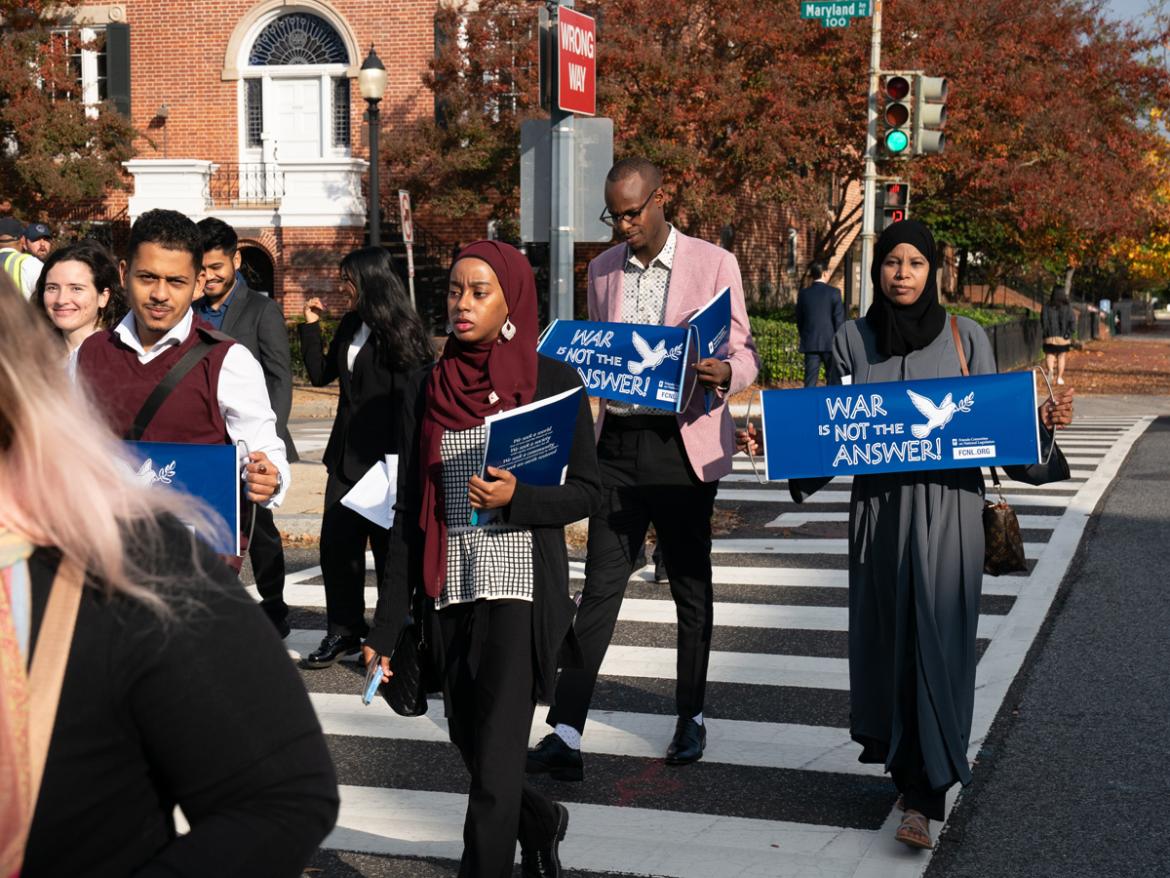 Young Advocates walking with "War is not the Answer" signs