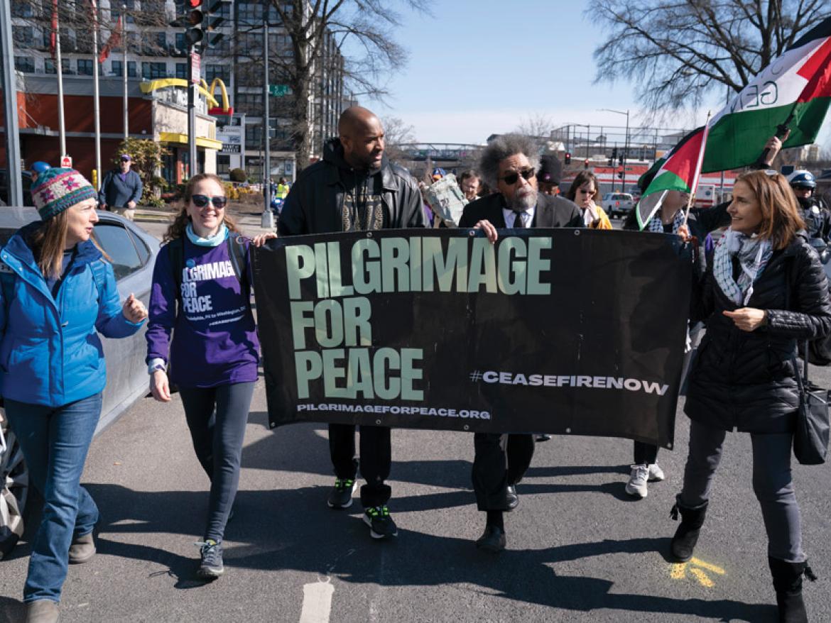 Leaders marching with a "Pilgrimage for Peace" banner