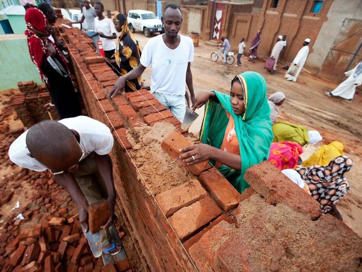 Sudanese youth building a community center