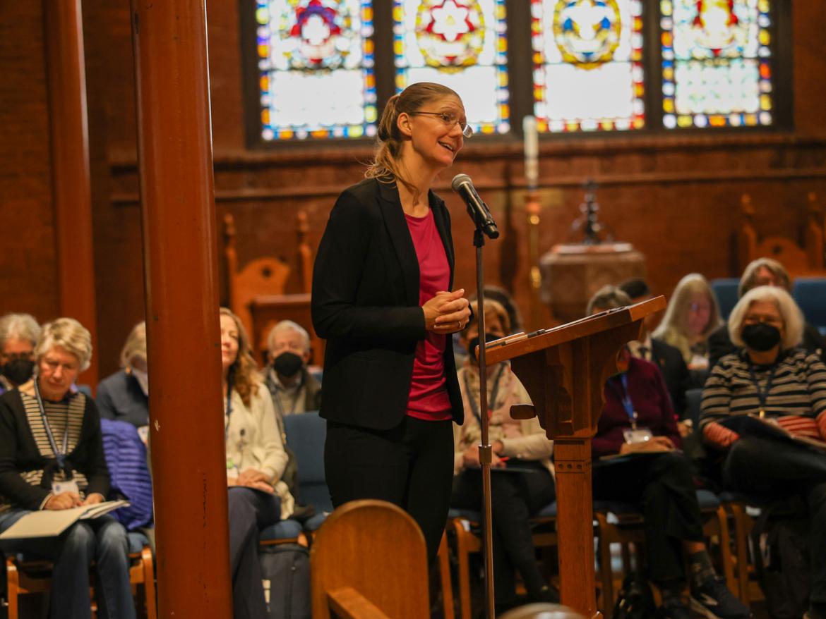 Amelia Kegan speaking at a microphone