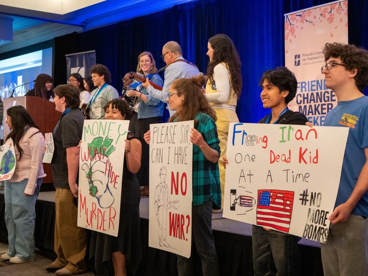 Activists with signs on stage