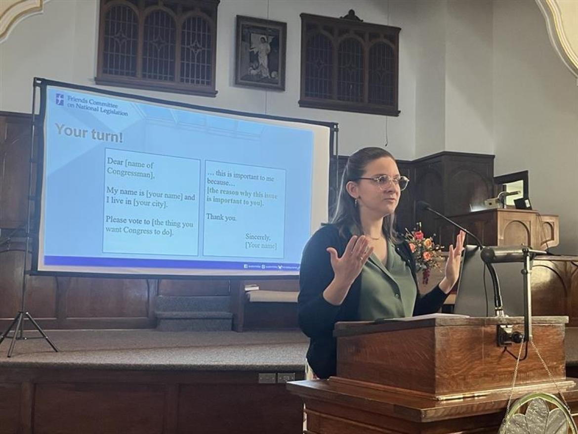 Susan Nahvi speaking in front of a screen