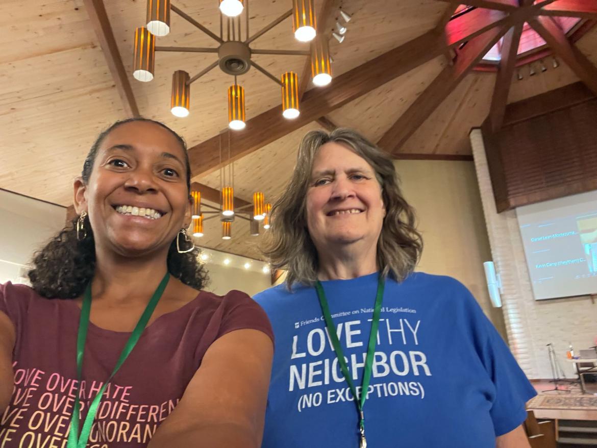 two women smiling at the camera wearing social justice tshirts