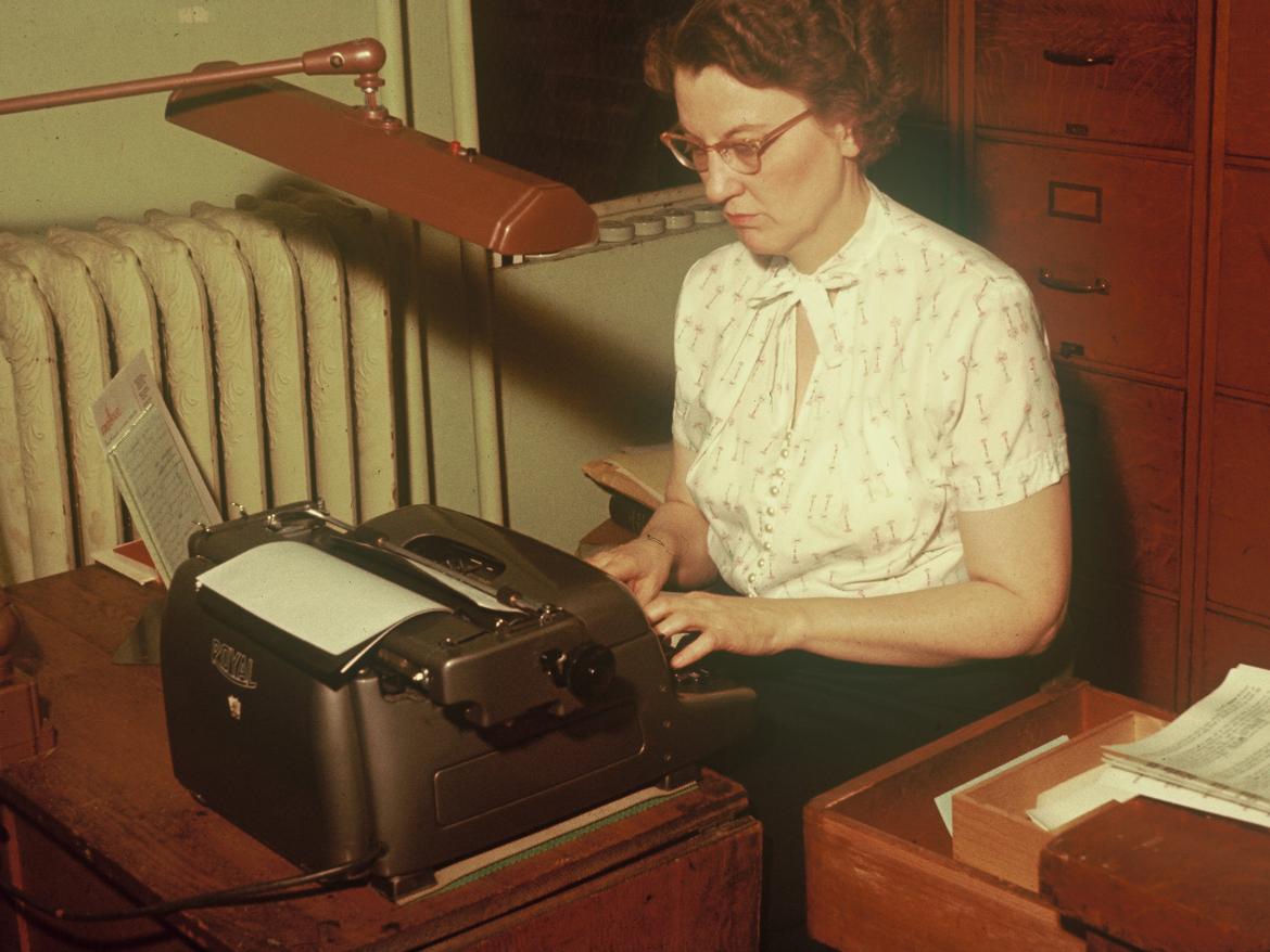 Woman sitting at a typewriter
