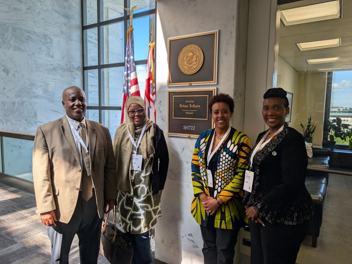 Four African peacebuilders in front of Sen. Schatz' office