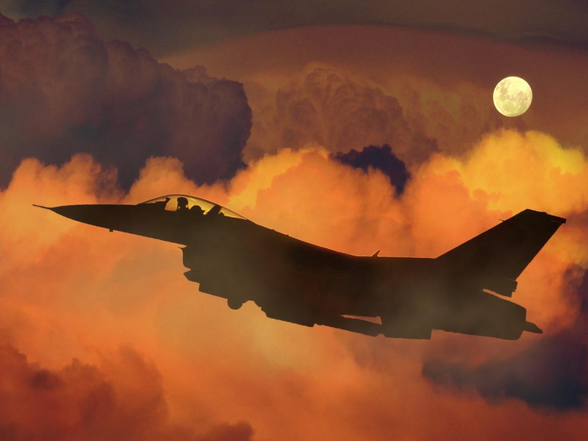 Military plane at sunset.