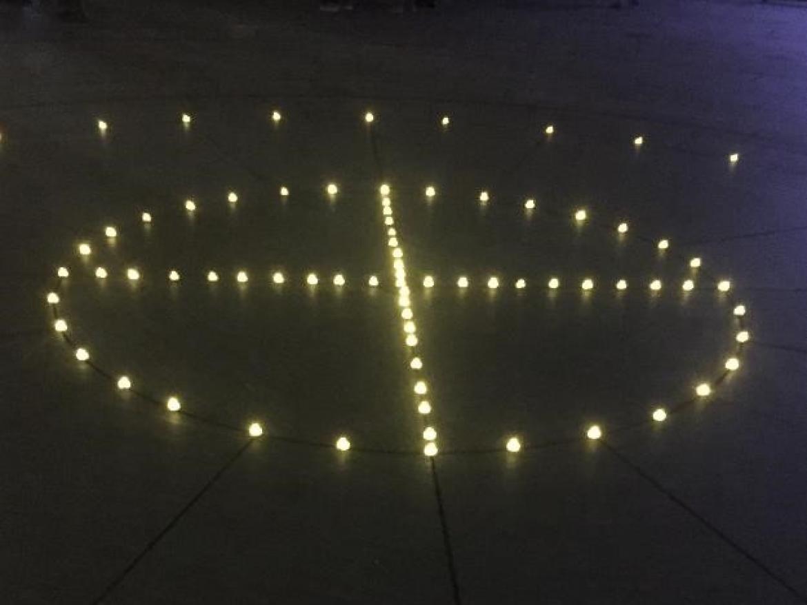 Candles in the shape of a medicine wheel at vigil for murdered and missing indigenous women.