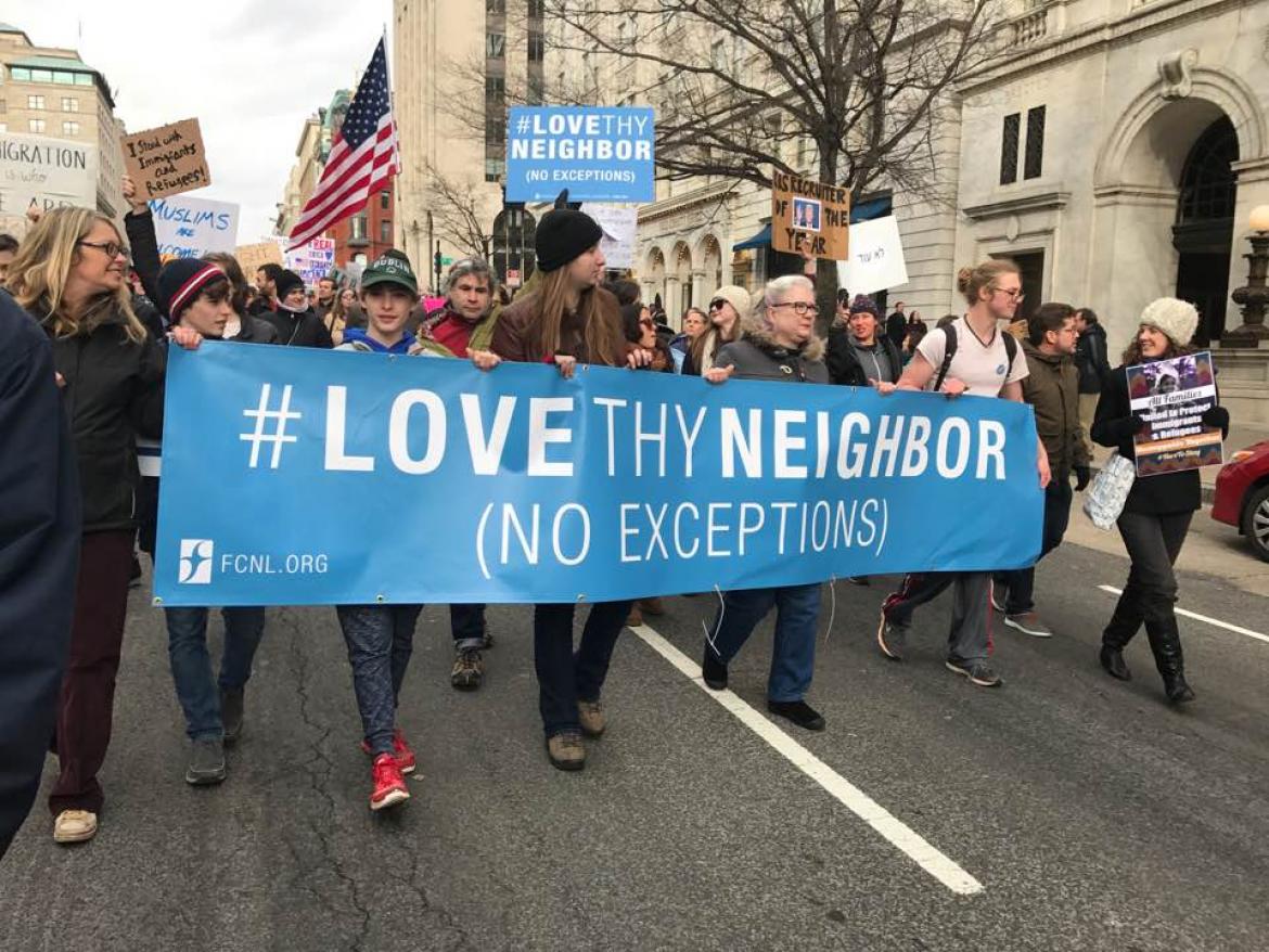 Christine Ashley and kids marching with Love Thy Neighbor Banner