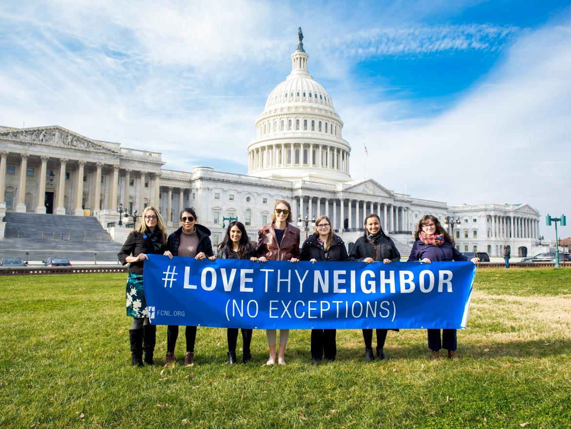 FCNL staff and partners at the capitol building with LoveThyNeighbor banner.