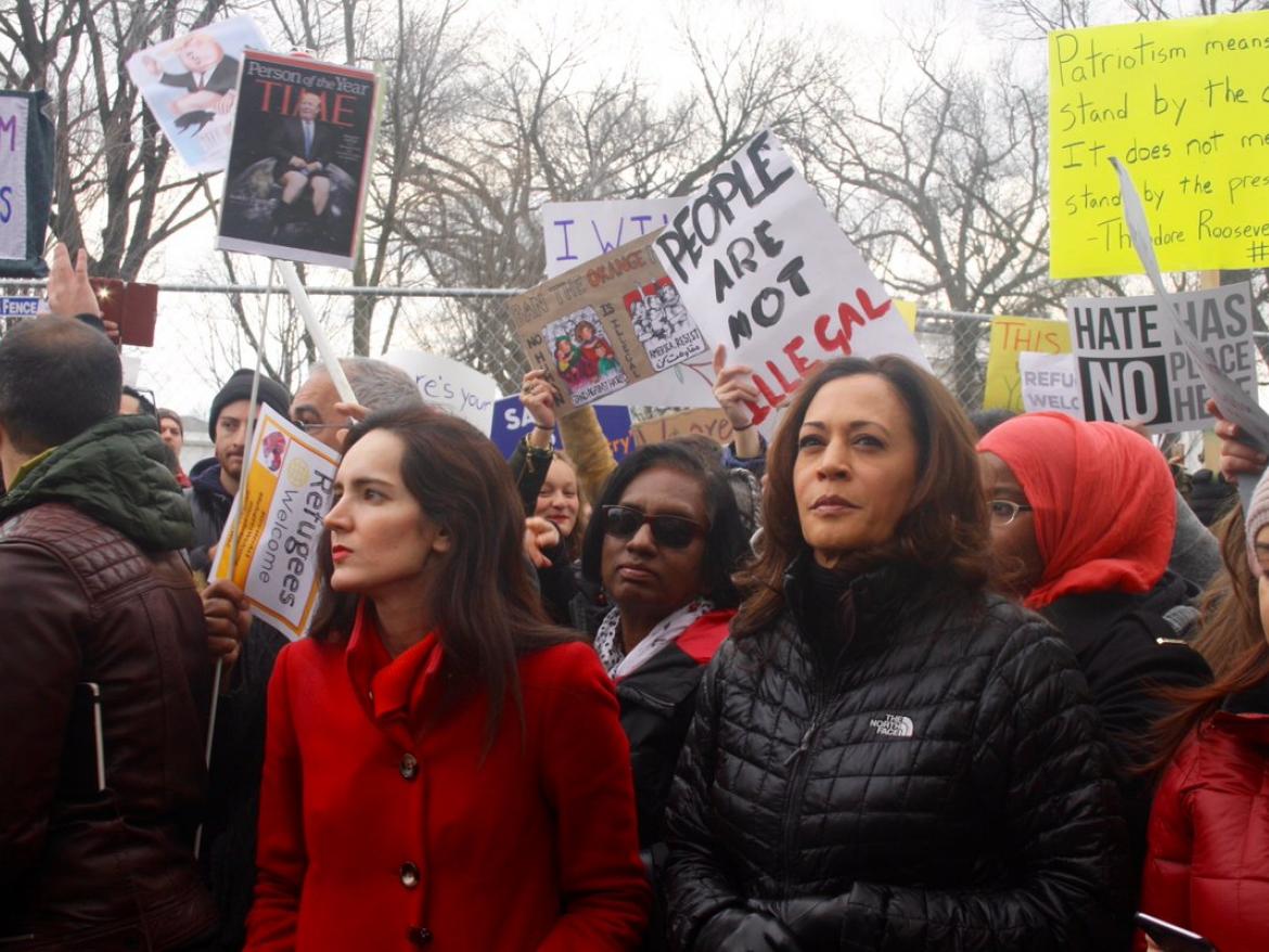 Yasmine stands next to Kamala Harris at a rally.