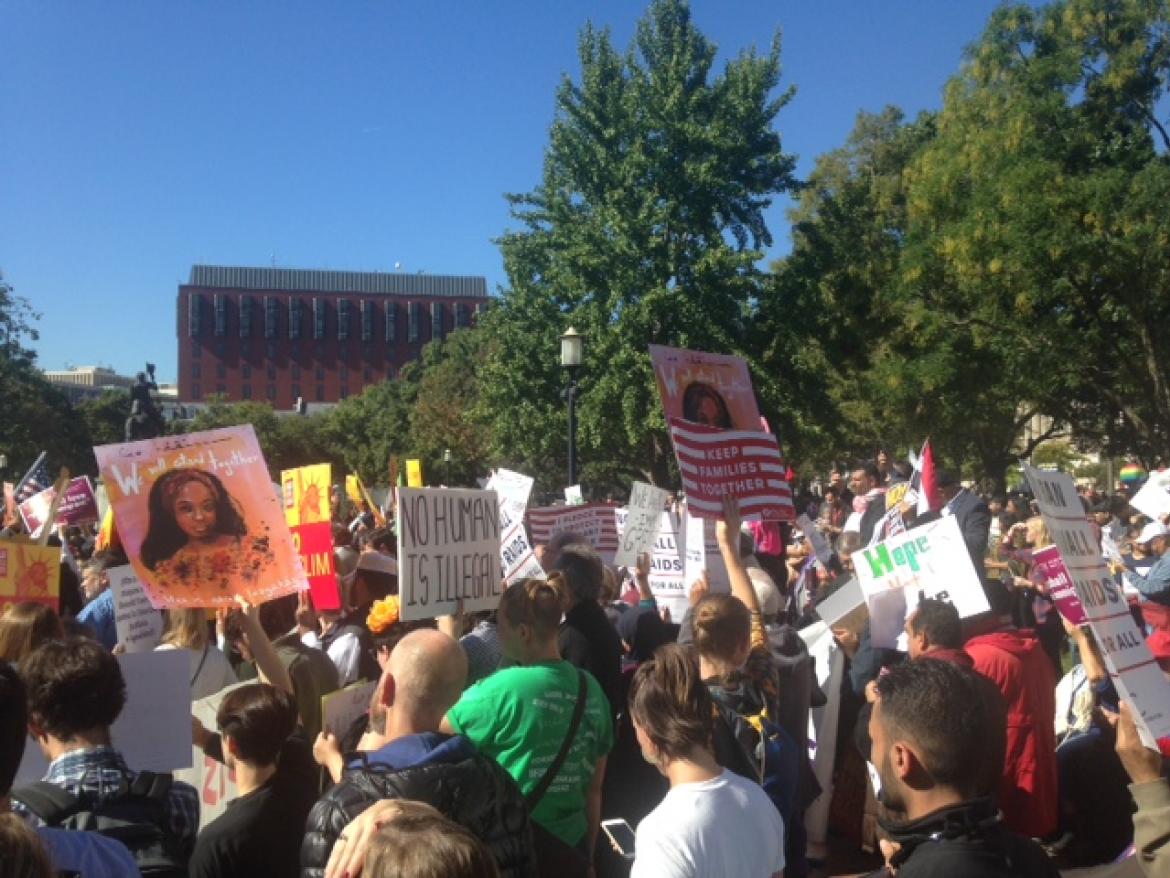 A crowd of protesters at the #NoMuslimBanEver March hold signs and chant in Lafayette Square on October 18, 2017. 