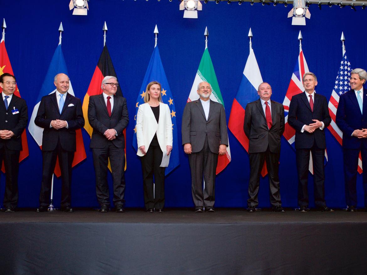 Diplomats stand in front of their flags after reaching the Iran deal