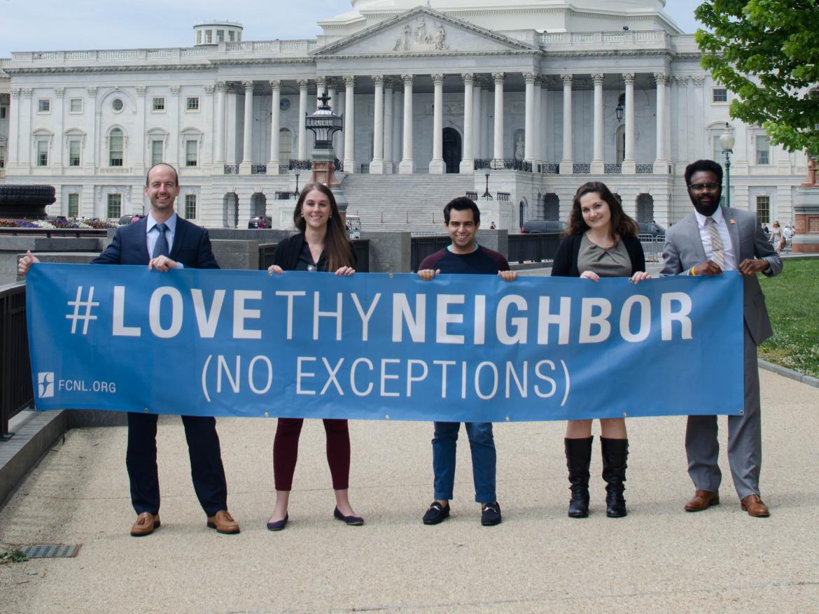 FCNL Staff holding Love Thy Neighbor (No Exceptions) banner