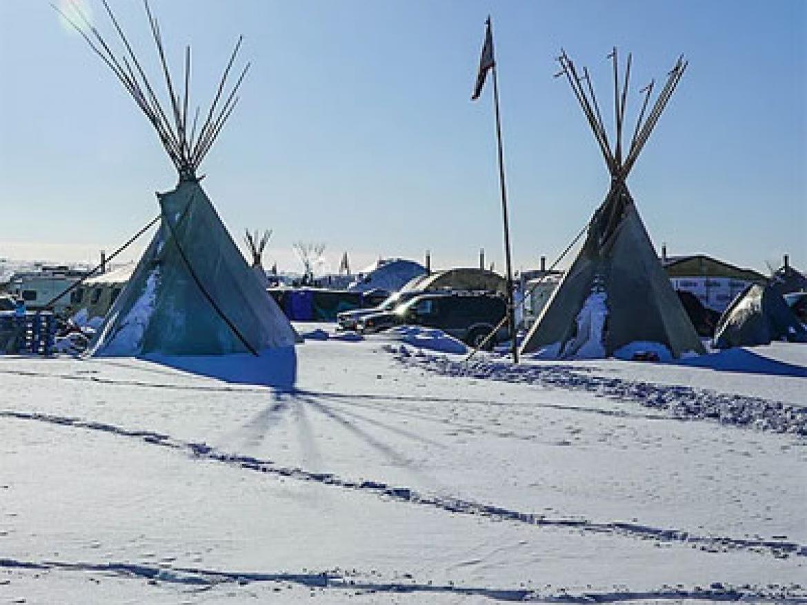 Teepees on a snow-covered field 