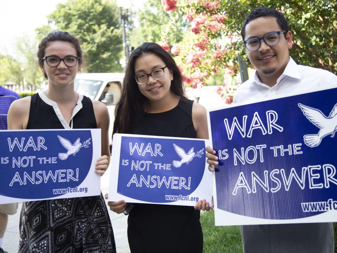 Group of advocates holding "War Is Not The Answer" signs