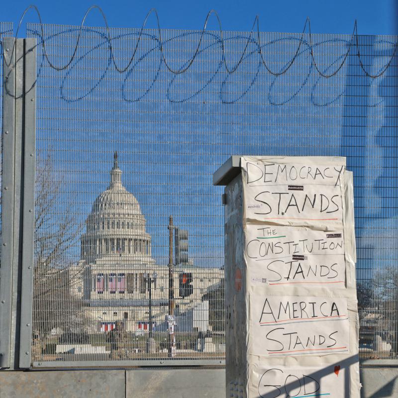"Democracy Stands, America Stands": Sign in front of Capitol fence