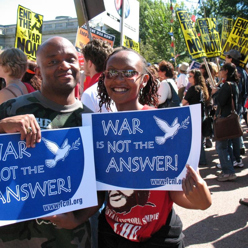 Advocates holding "War is Not the Answer" signs 