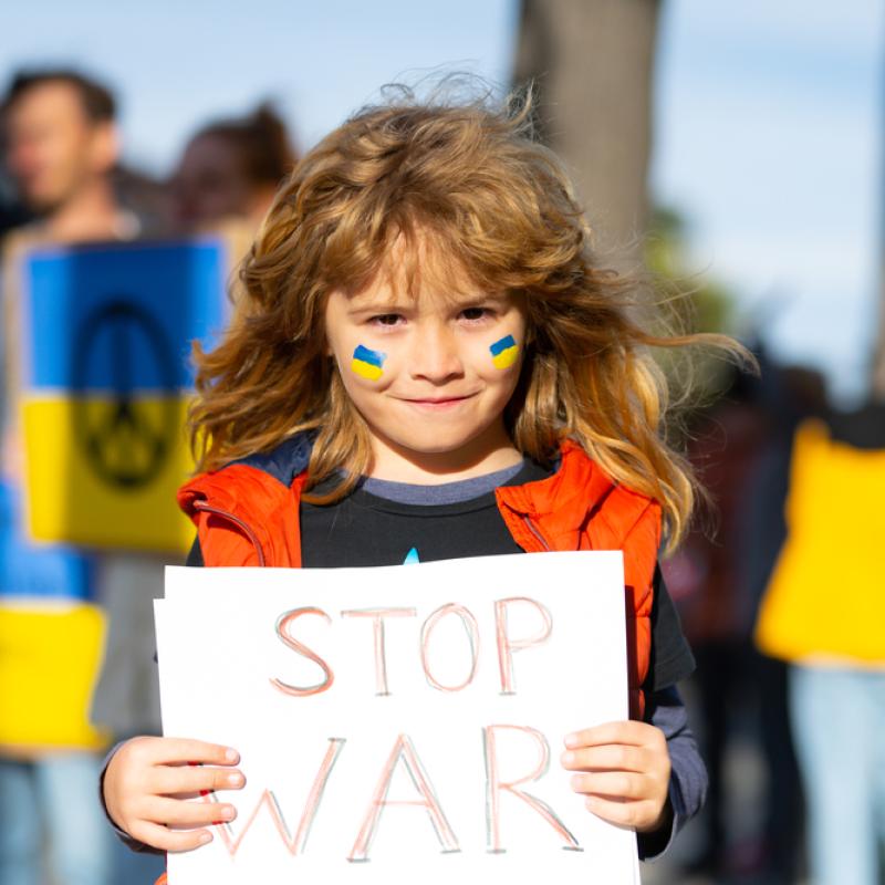 Ukraine protest; child holding a sign that says "stop war"