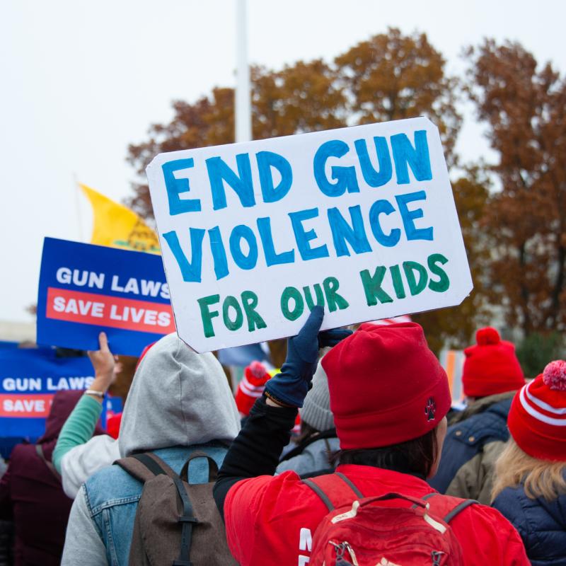 Marcher holds sign that says "End gun violence for our kids"