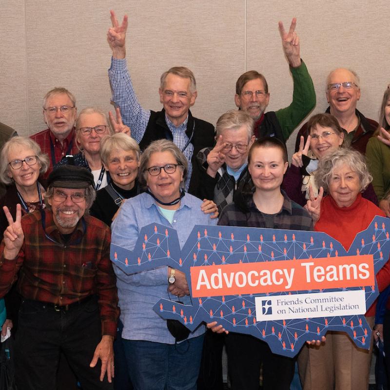 A group of Advocacy Teams members make peace signs