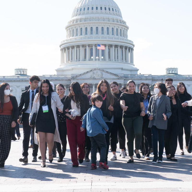 Group of Spring Lobby Weekend advocates walk together in front of the U.S. Captiol Building