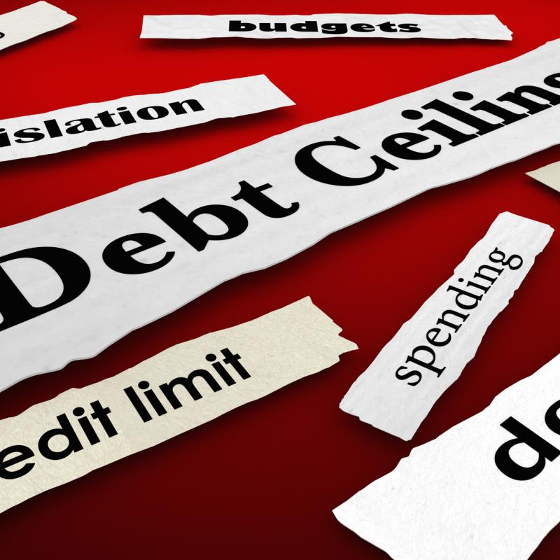 Graphic: torn out strips of paper on a red background feature phrases like, "debt ceiling" "credit limint" "Deficit" "Legislation"