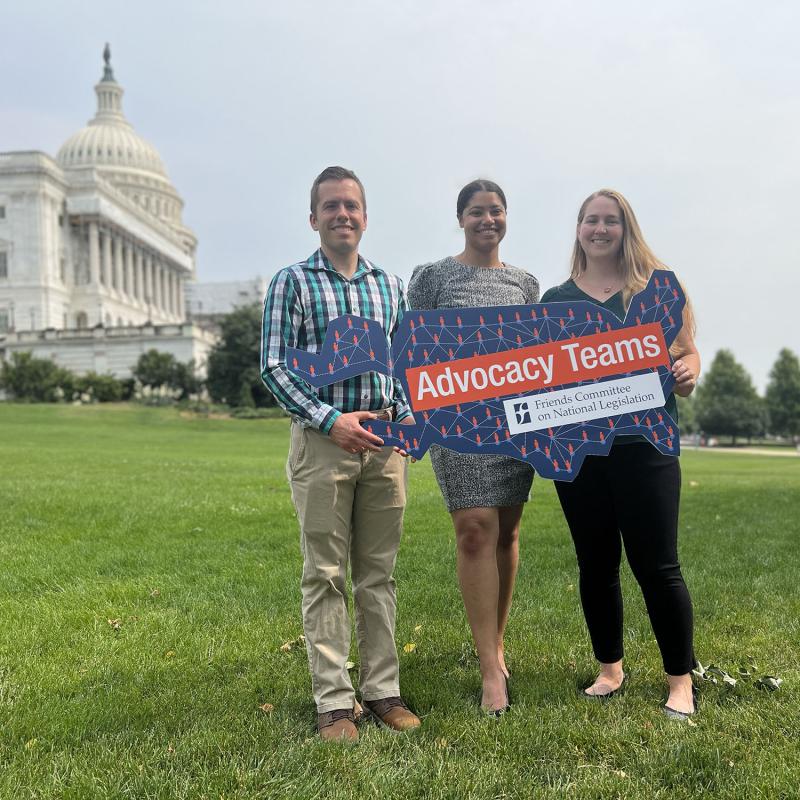 Advocacy Teams organizers Tim, Mwan and Sarah hold "Advocacy Teams" sign in front of U.S. Capitol