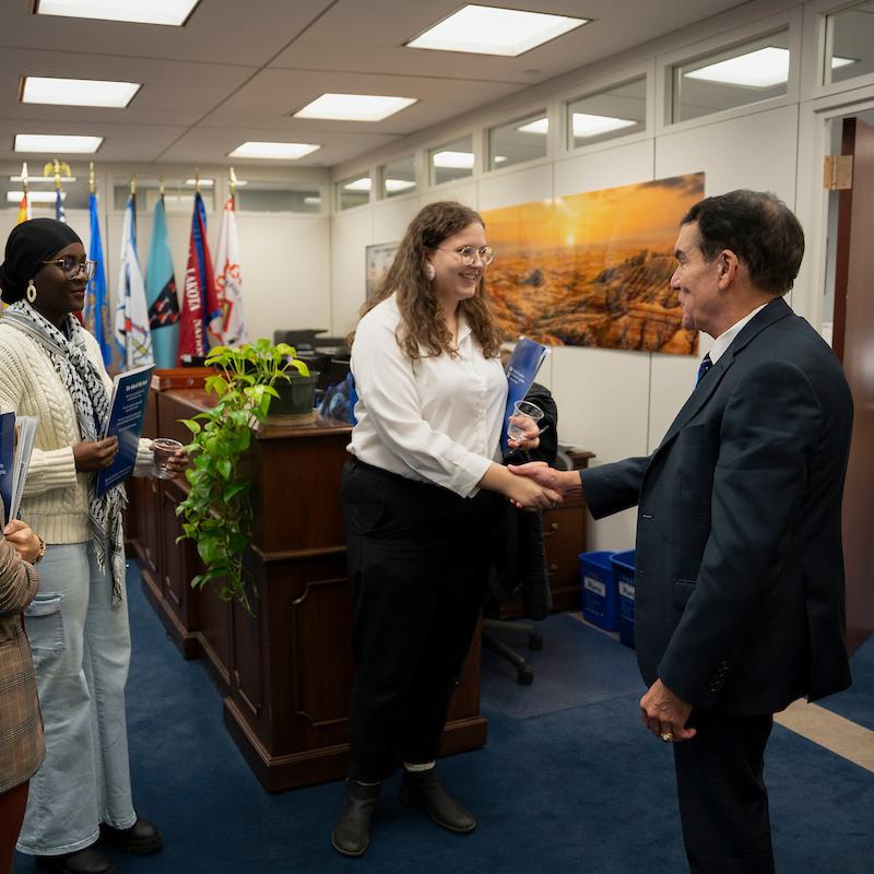 A group of thre young advocates shake hands with staffer during lobby visit